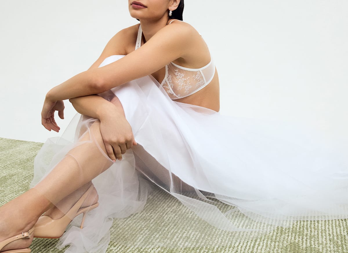 Fashion campaign image art-directed for Journelle: a model in white tulle on a pale green rug